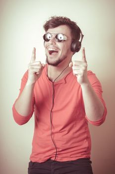 Stylish man listening to music on vignetting background