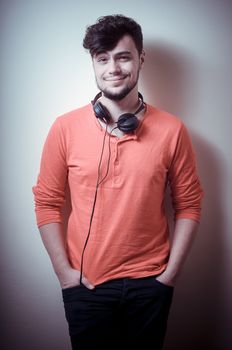 Stylish man listening to music on vignetting background