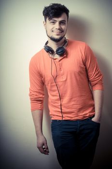 Stylish man listening to music on vignetting background