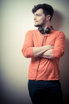 Stylish man listening to music on vignetting background