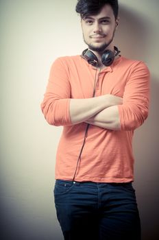 Stylish man listening to music on vignetting background