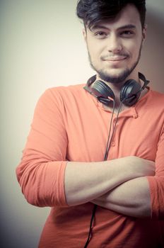 Stylish man listening to music on vignetting background