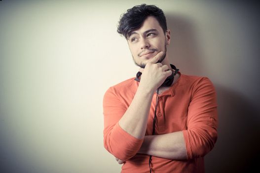 Stylish man listening to music on vignetting background