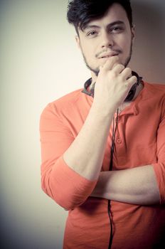 Stylish man listening to music on vignetting background