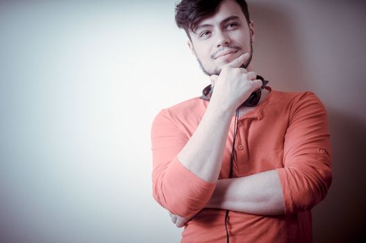 Stylish man listening to music on vignetting background