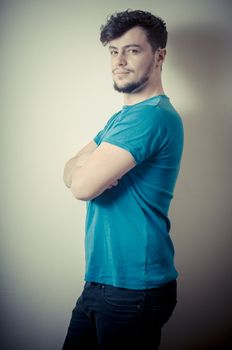 portrait of stylish young man with blue shirt on vignetting background