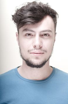 portrait of stylish young man with blue shirt on vignetting background