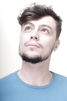 portrait of stylish young man with blue shirt on vignetting background