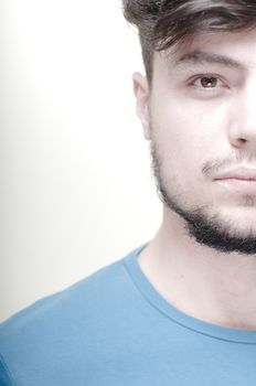 portrait of stylish young man with blue shirt on vignetting background