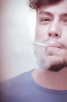 stylish young modern man with cigarette on vignetting background