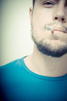 stylish young modern man with cigarette on vignetting background