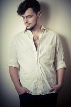 young modern stylish man on vignetting background