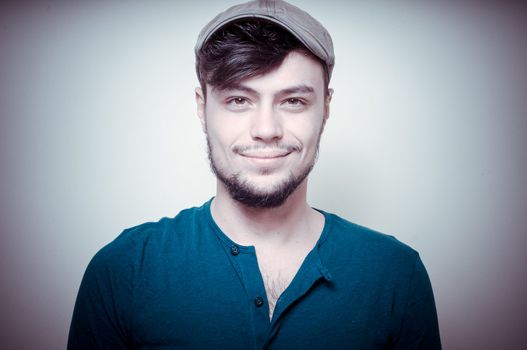 young modern stylish man with cap on vignetting background