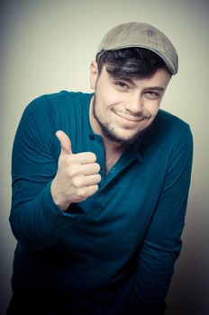 young modern stylish man with cap on vignetting background