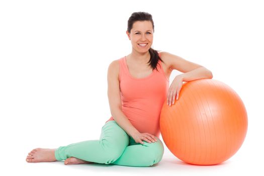 Beautiful pregnant woman with ball isolated over white background