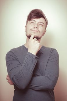 young modern stylish man with cap on vignetting background