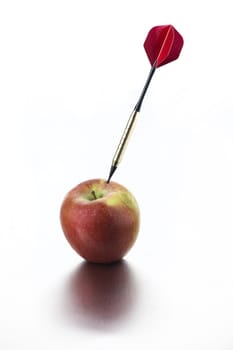 Red apple with dart on white