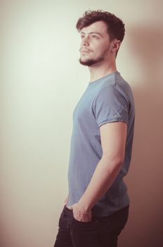 portrait of stylish young man with blue shirt on vignetting background