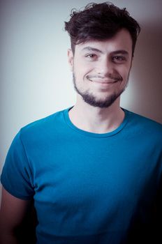 portrait of stylish young man with blue shirt on vignetting background