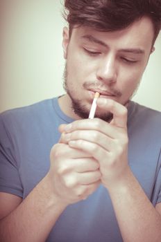 stylish young modern man with cigarette on vignetting background