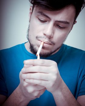 stylish young modern man with cigarette on vignetting background