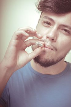 stylish young modern man with cigarette on vignetting background