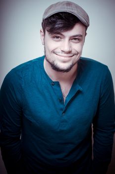 young modern stylish man with cap on vignetting background