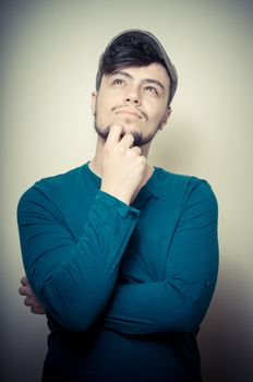 young modern stylish man with cap on vignetting background