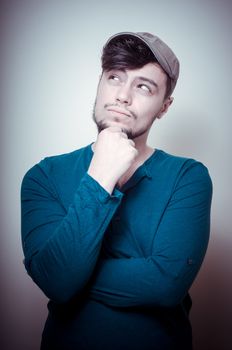 young modern stylish man with cap on vignetting background