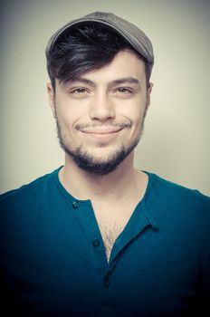 young modern stylish man with cap on vignetting background