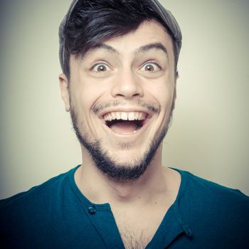 young modern stylish man with cap on vignetting background