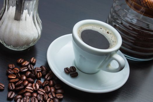 cup of black coffee with biscuits