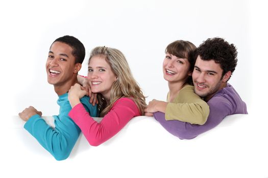 Two couples stood with blank poster