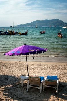 Two chairs and umbrella on the beach, Thailand