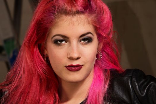 Close up of young punk rocker female with pink hair