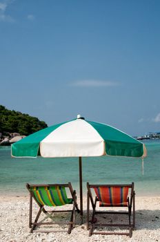 Two chairs and umbrella on the beach, Thailand