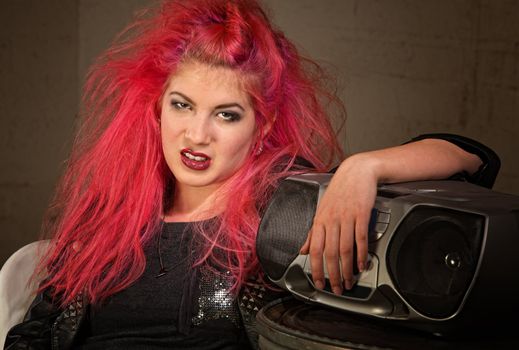 Moody teenage European female with pink hair and radio