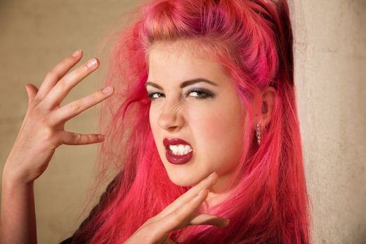 Emotional young Caucasian punk woman gesturing with her hands