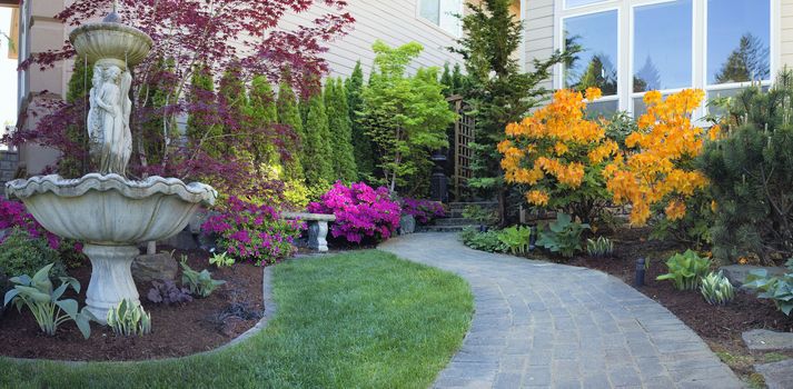 Frontyard Landscaping with Water Fountain and Brick Pavers Path with Azalea Flowers in Bloom