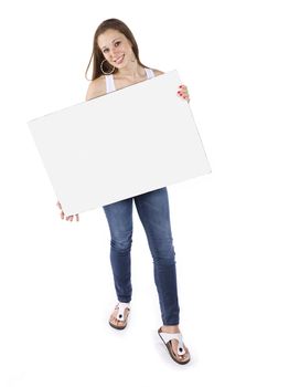 View of a teenage girl holding a blank placard over white background.