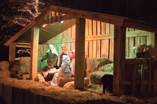 Live Christmas nativity scene reenacted in a medieval barn