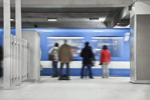 People waiting the next metro. A long exposure of the wagon that show the movements and a blurry people just standing there.Shot during the morning rush hour.