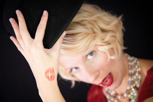 Beautiful lady with an old fashioned style shot in studio with a black background.