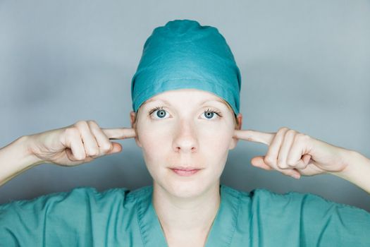 Young nurse in studio on a gray background