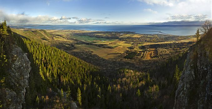 This was such an amazing view that I had to spend couple of hours doing this panorama. You can see how steep the cliff is. I was a cold day of autumn. In front you can see the sea of Carleton, Qc, Canada. This is actually a view from the top of the St-Joseph Mountain. The resolution is amazing so feel free to zoom to see all these little houses and fields. Far away on the other side of the see is the New-Brunswick.