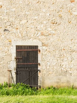 Old wooden door in an old stone wall