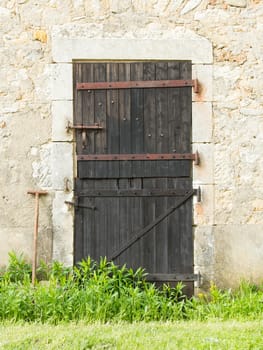 Old wooden door in an old stone wall