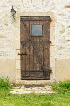 Old wooden door in an old stone wall