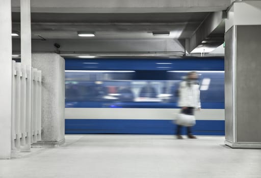 Someone waiting the metro. A long exposure of the wagon that show the movements and a blurry men just standing there.