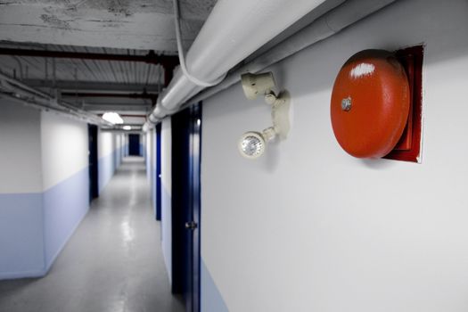 Fire Bell Alarm (red) with emergency light too in a long blue corridor.